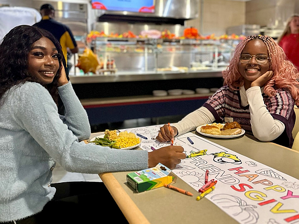 2 students at a coloring station